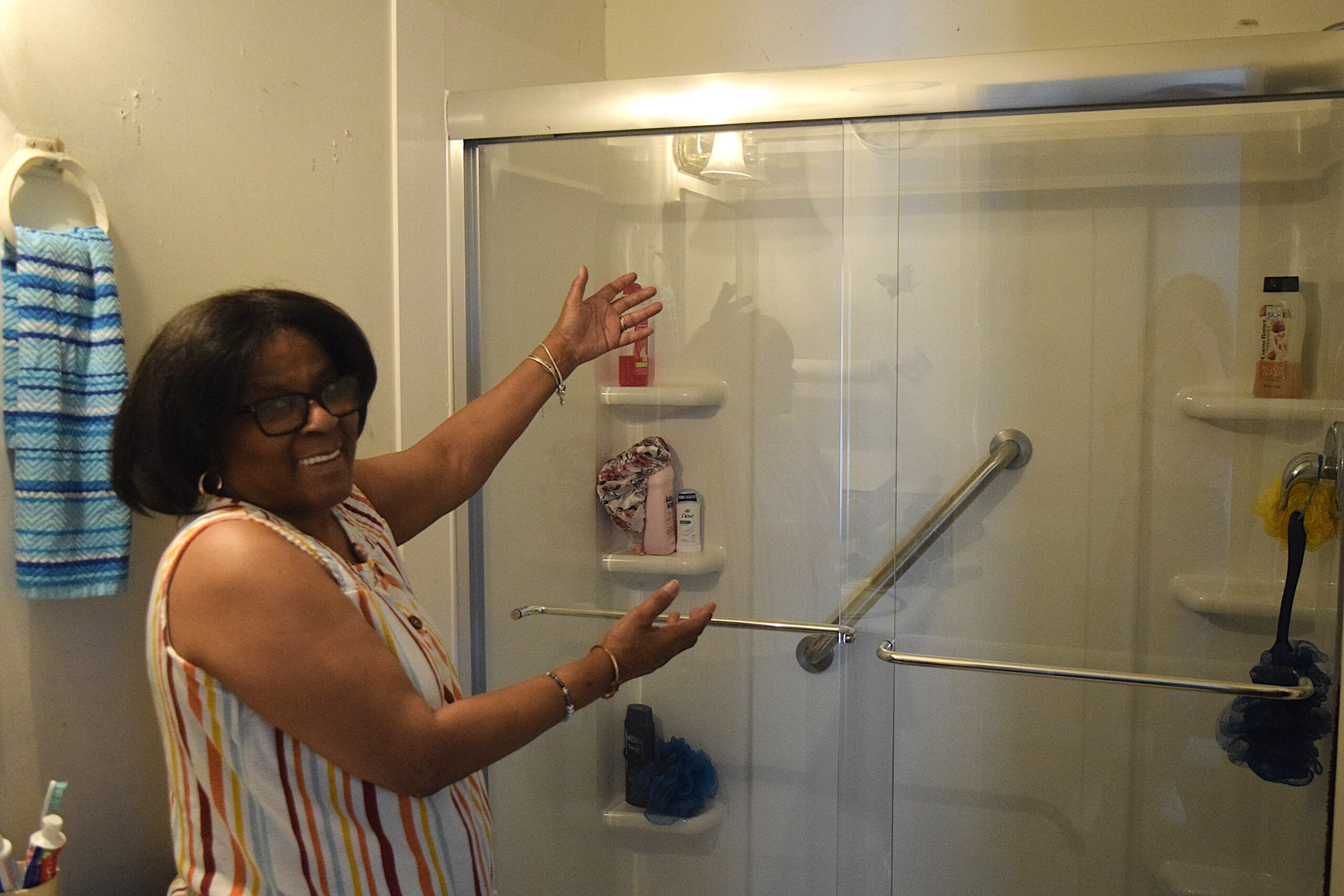 Homeowner smiling with her new no-step shower